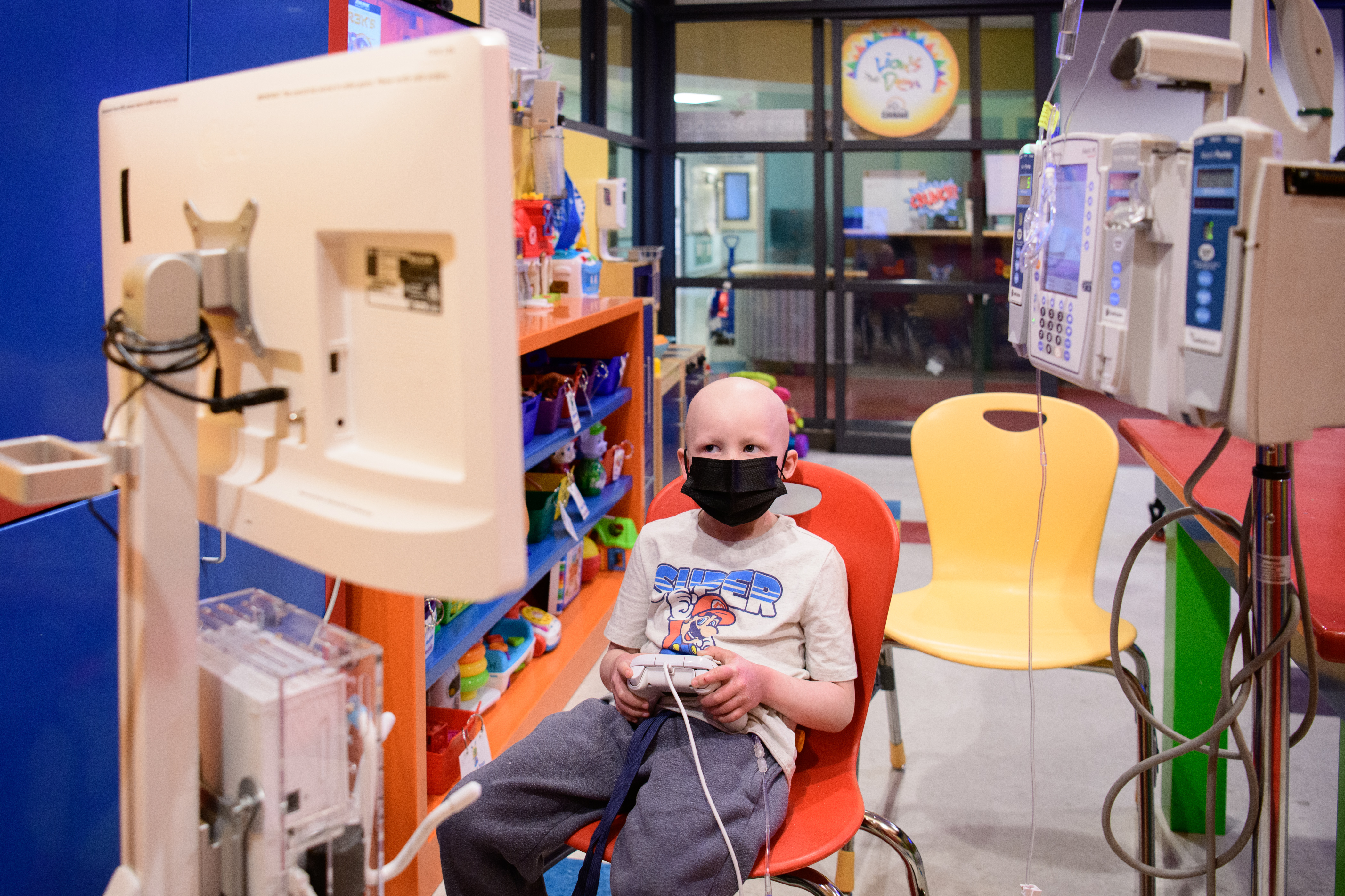 Patient with mask on video gaming in the Family Resource Center
