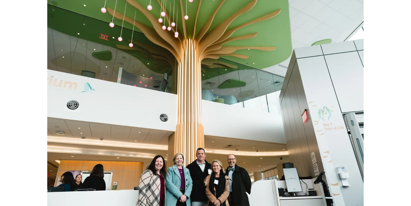 Big Y team in front of Big Y Tree of Life