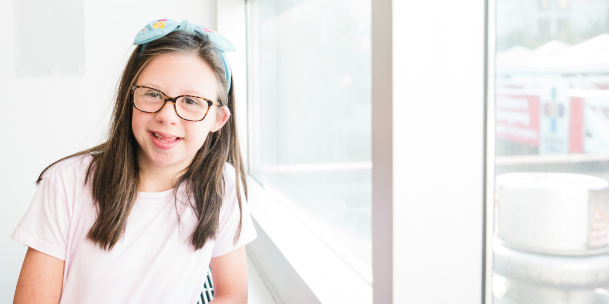 Ellie smiling in a patient room