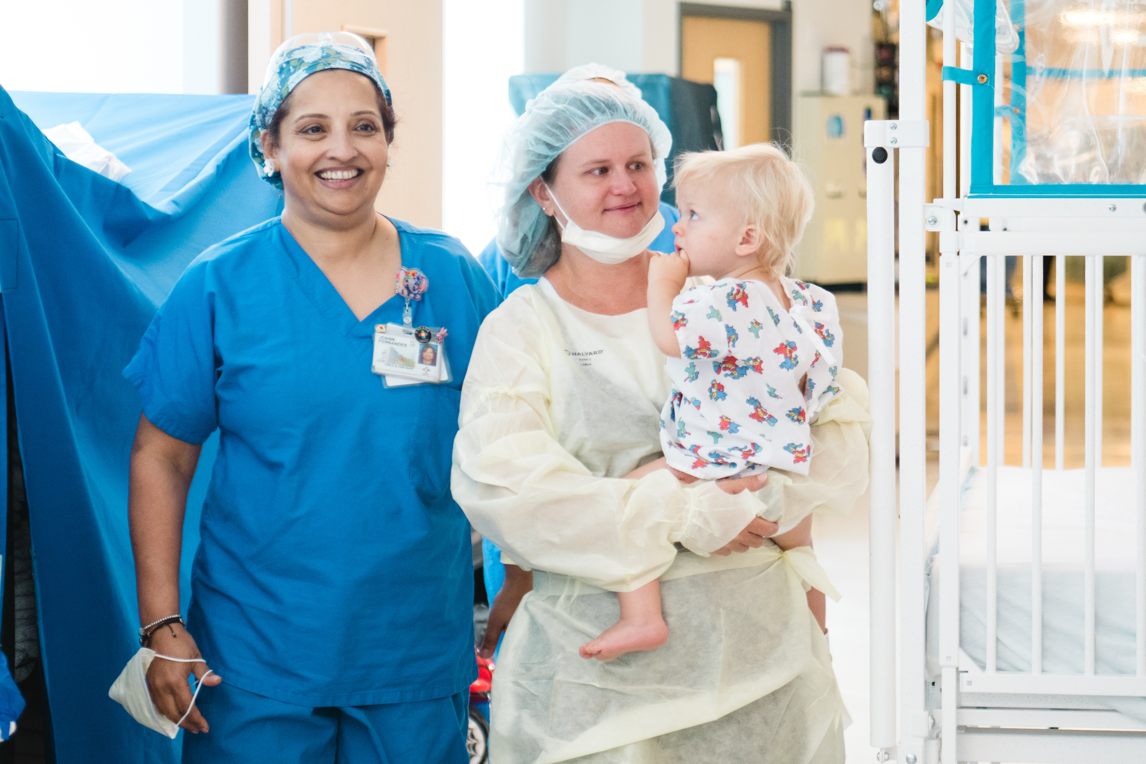 Anesthesiologist smiles walking patient down the hall