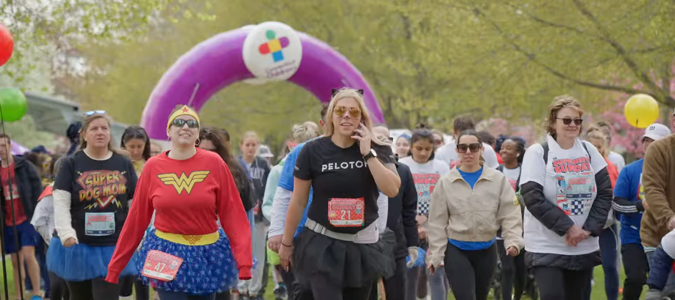 Superheroes running the 2025 5K race