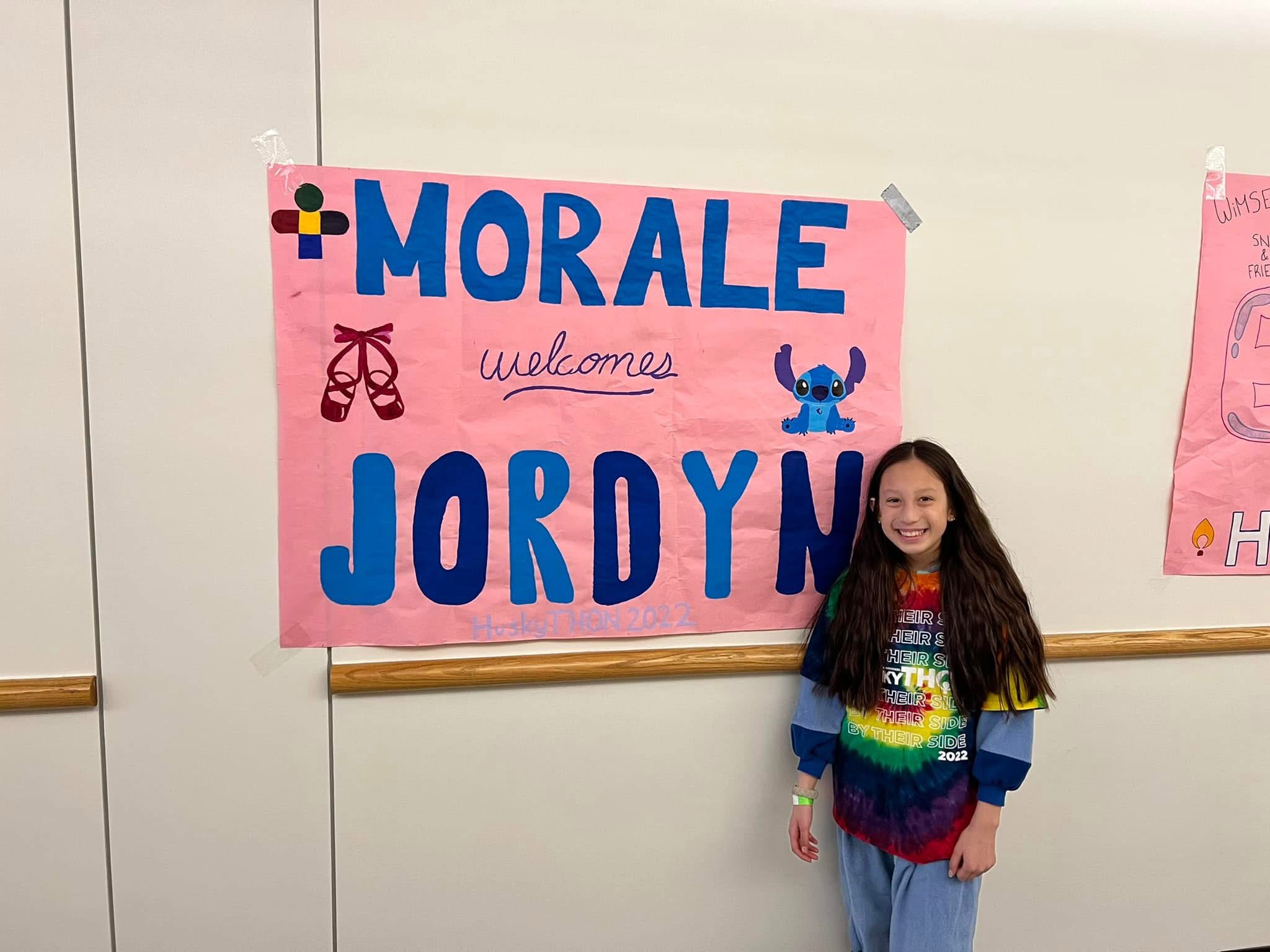 Jordyn standing next to her morale sign