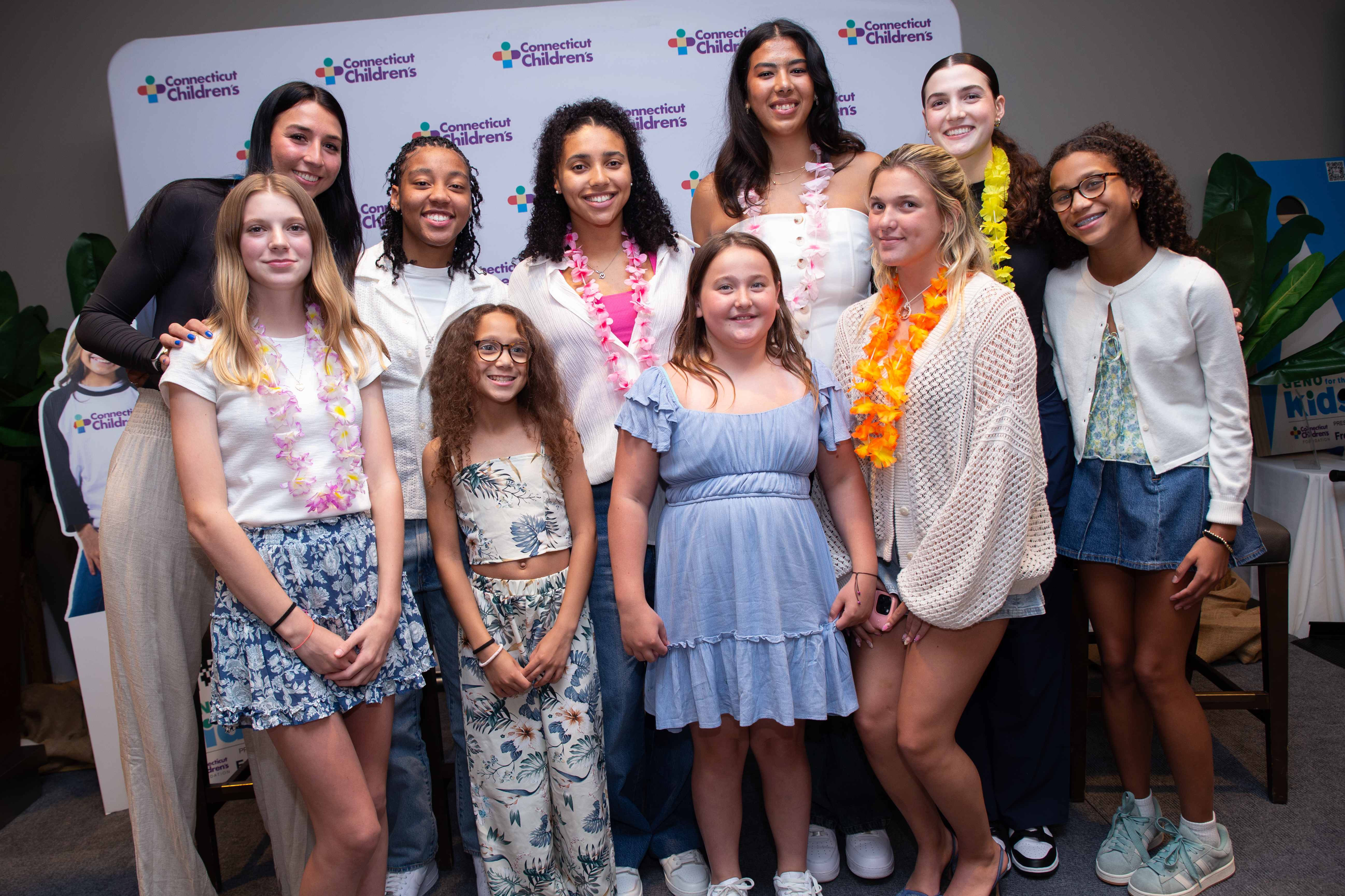 UConn WBB team with kids at Geno dinner 2025