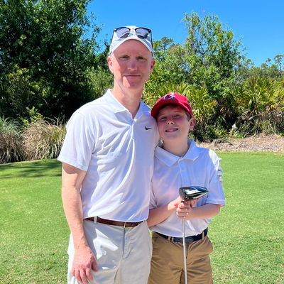 William playing golf with his dad