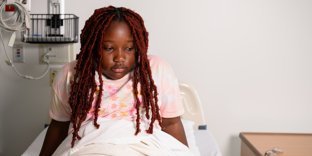 Zendaya sitting in a hospital bed