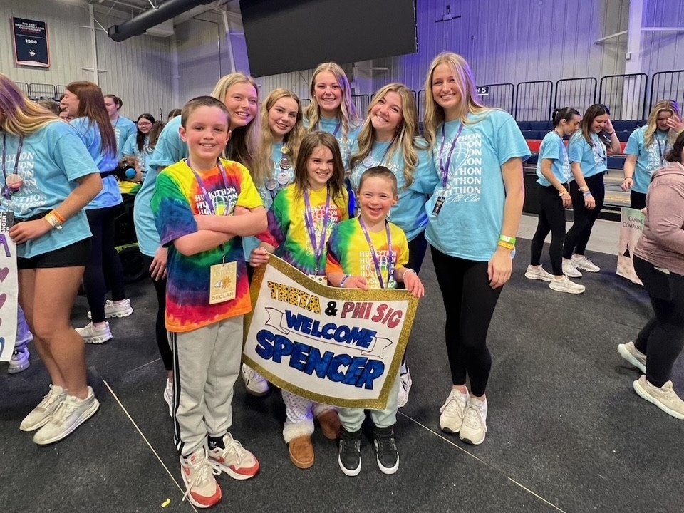 Patient Spencer standing with his family and Dance Representatives