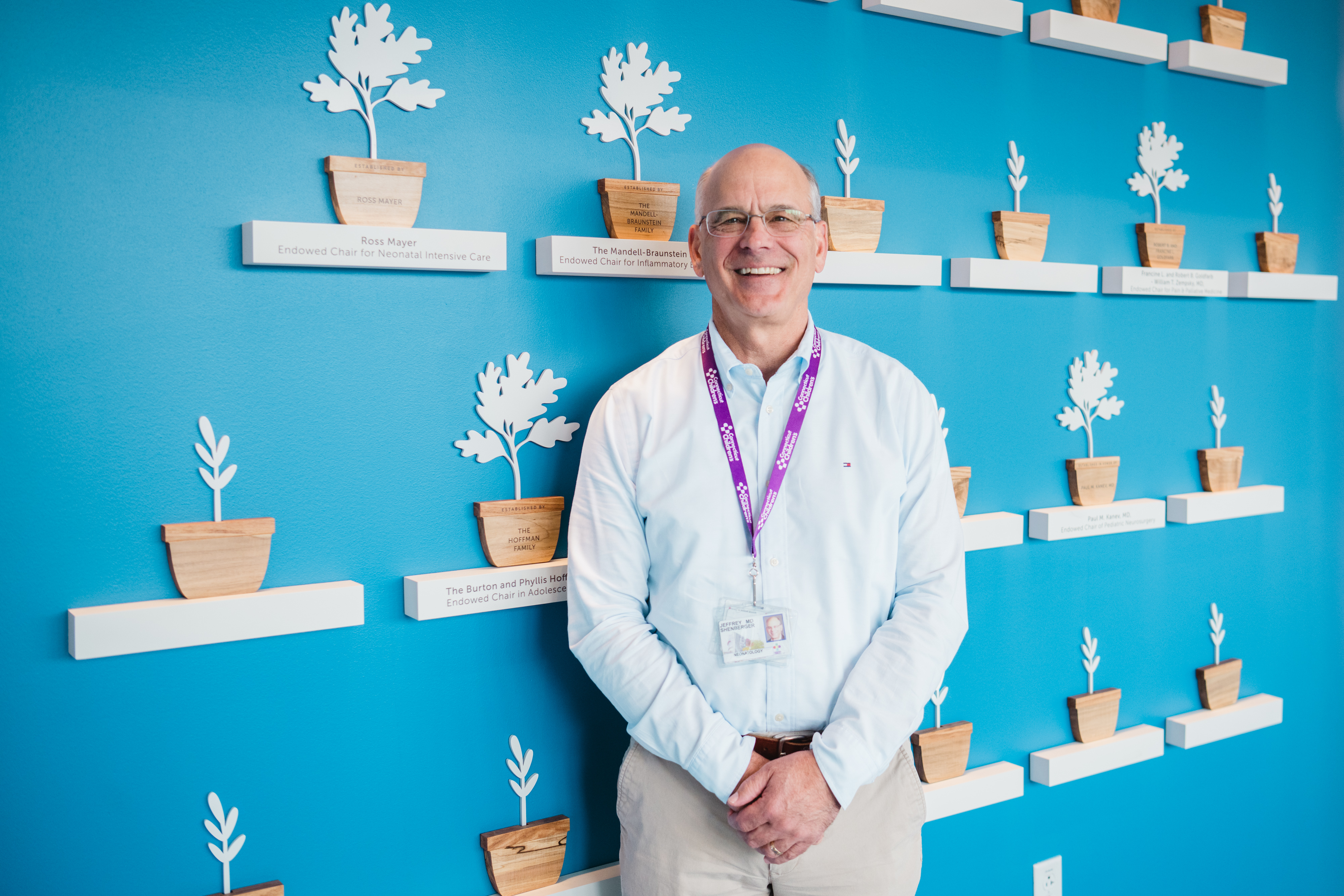 Doctor standing in front of Endowed Chair Wall