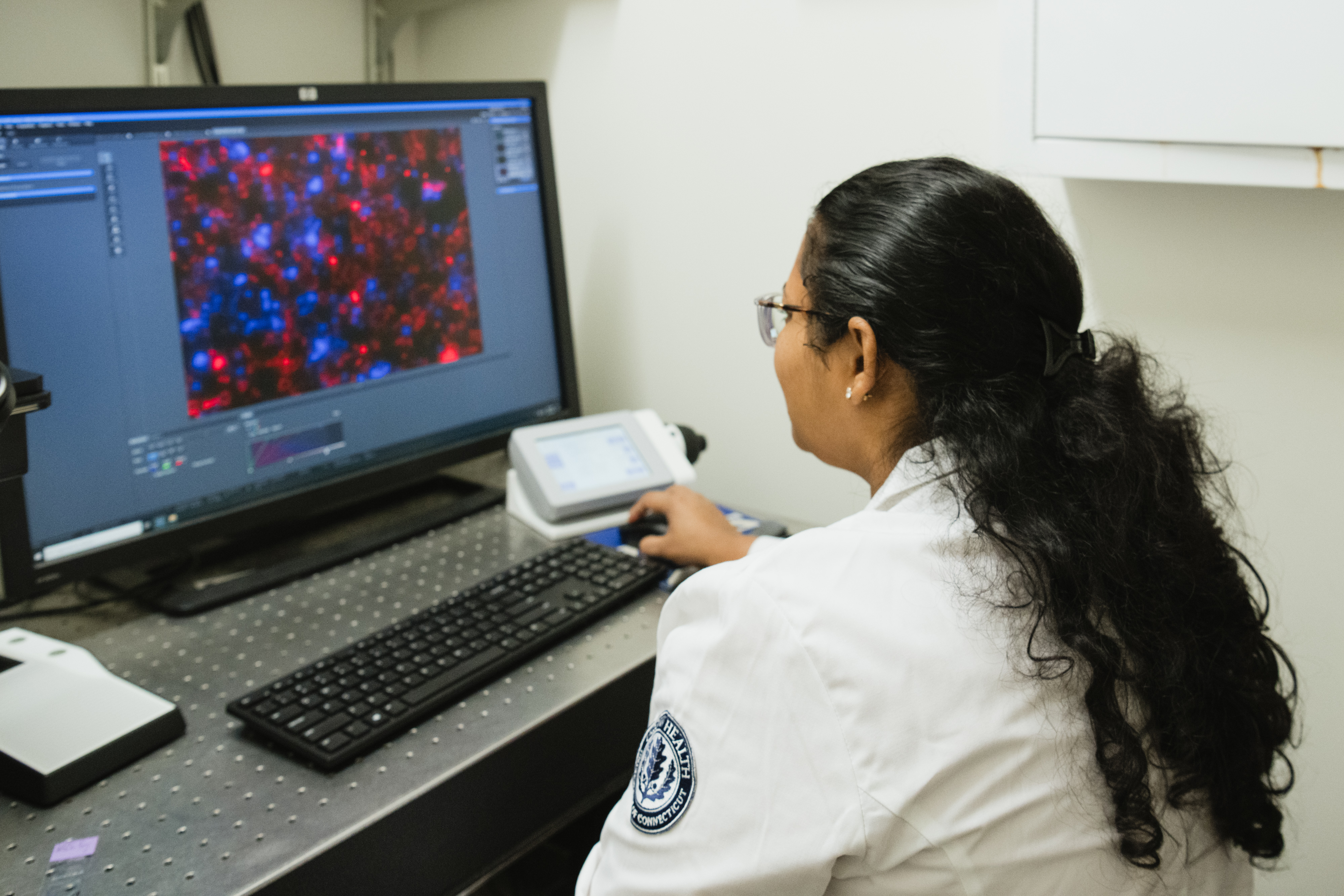 Dr. Majumder viewing data on the computer in the lab