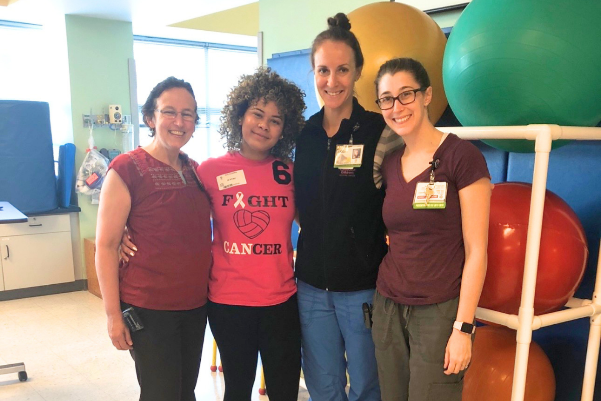 Evelyn smiling with her care team