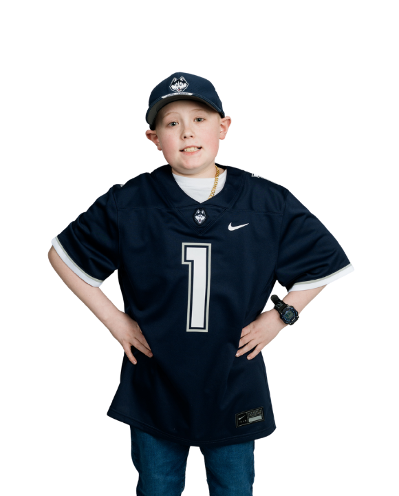 Carson posing wearing a UConn jersey on