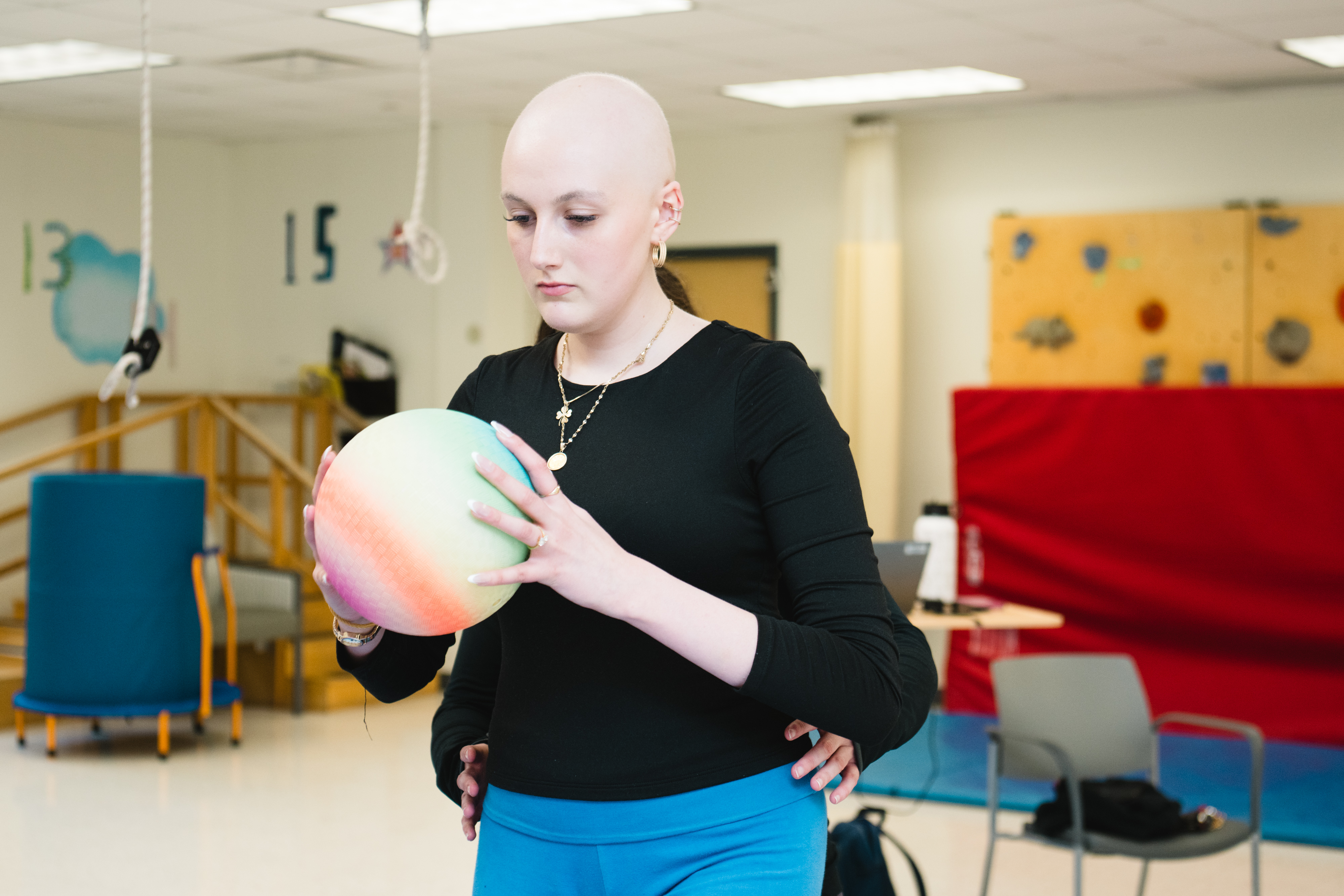 Teen patient holding ball balancing