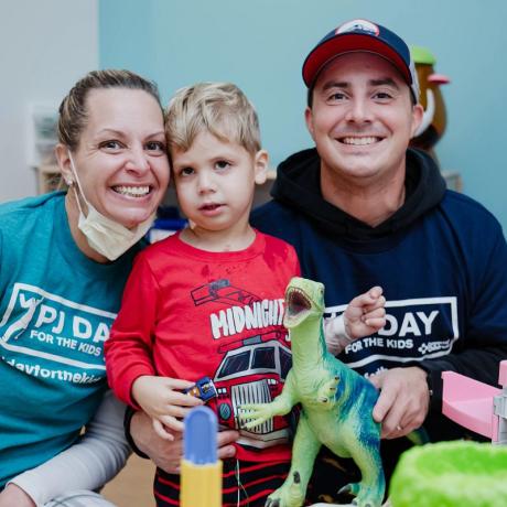 A patient participates in PJ Day with his care team and family