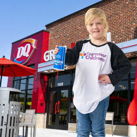 All-Star Emma holds a DQ Blizzard in front of a store