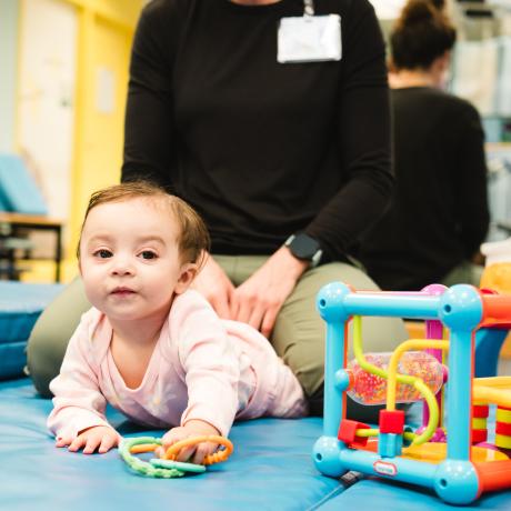 Baby playing with toys during Physical Therapy session