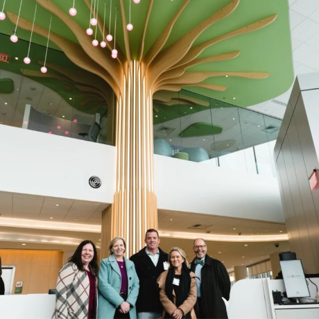 Big Y team in front of Big Y Tree of Life