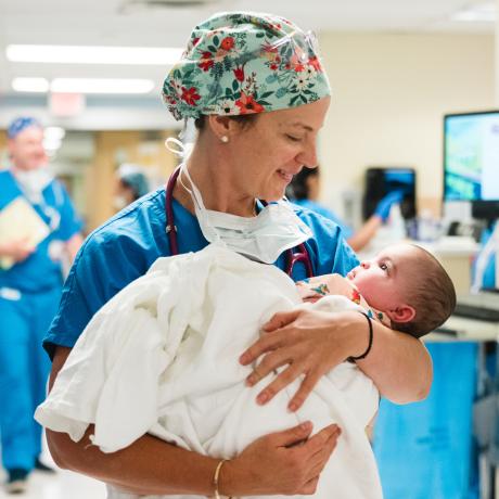 Anesthesiologist holds infant