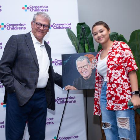 Geno and Ana smiling with painting