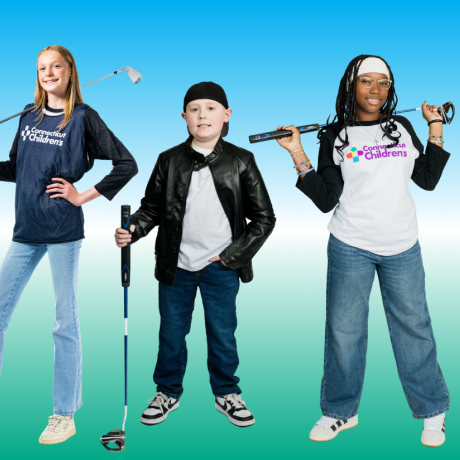 Patients holding golf clubs smiling
