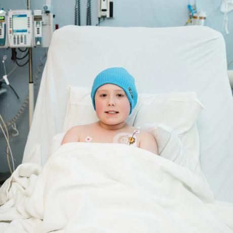 All-Star Carson wearing blue hat in hospital bed getting treatment