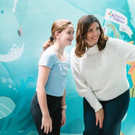 Mom and daughter taking a selfie at the selfie wall