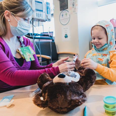 Patient practicing port access on teddy bear