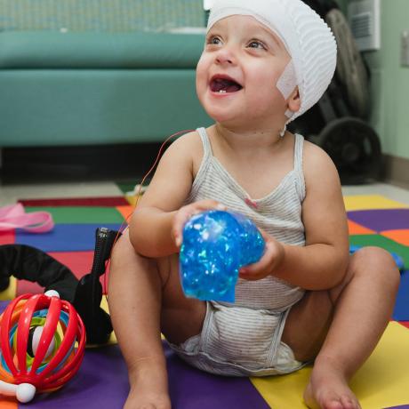 Young patient playing with toys smiling