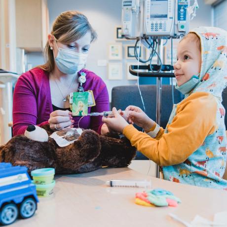 Patient practicing port access on teddy bear