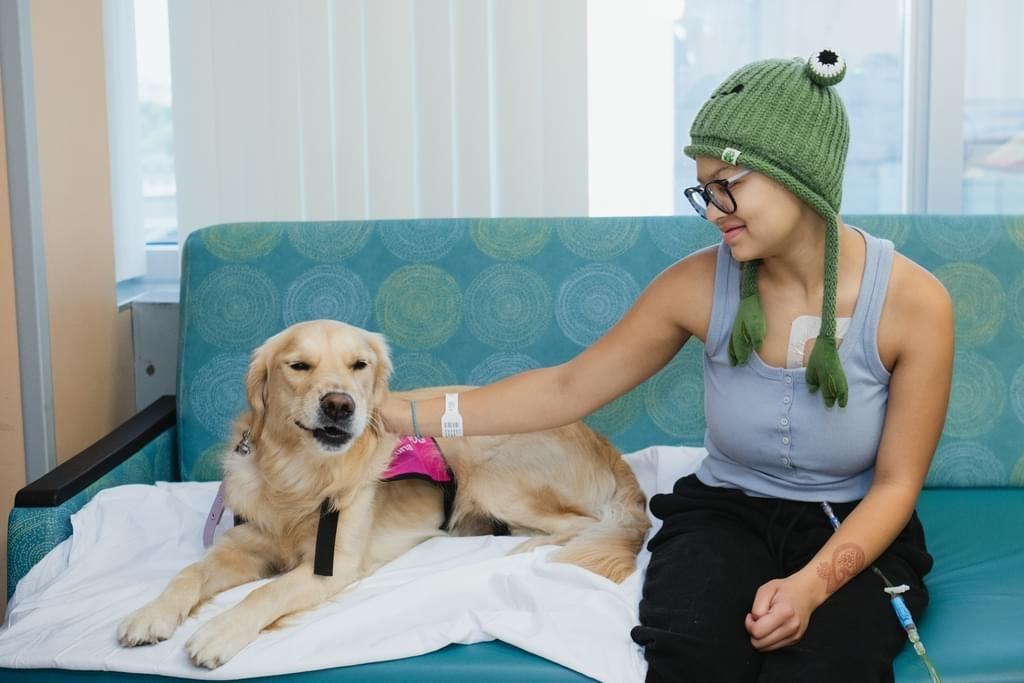 Ana with therapy dog during treatment