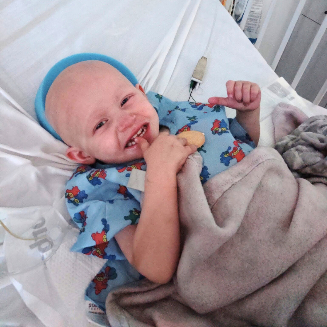 Anastasia lying in bed smiling