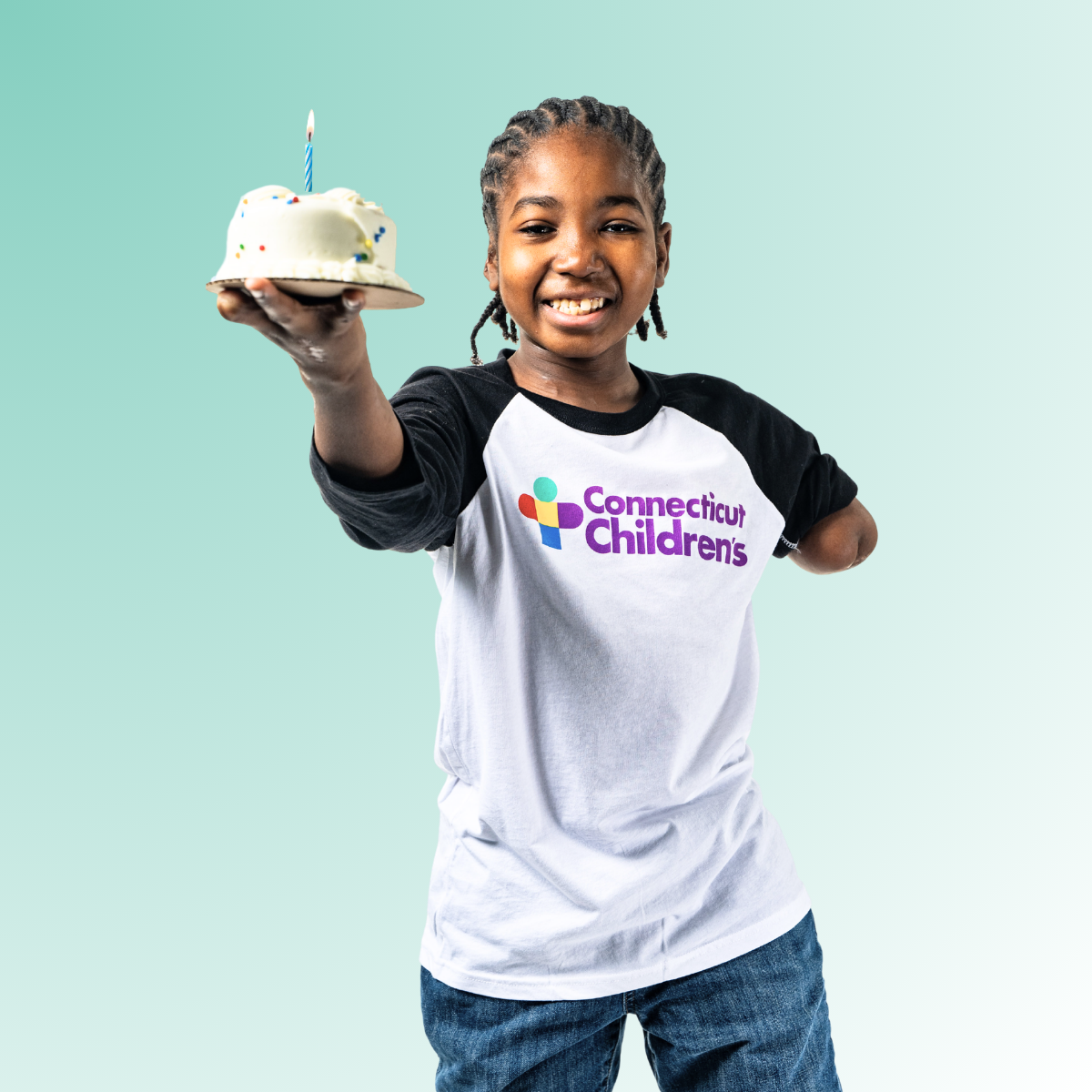 Patient Nate holding a cake with a candle