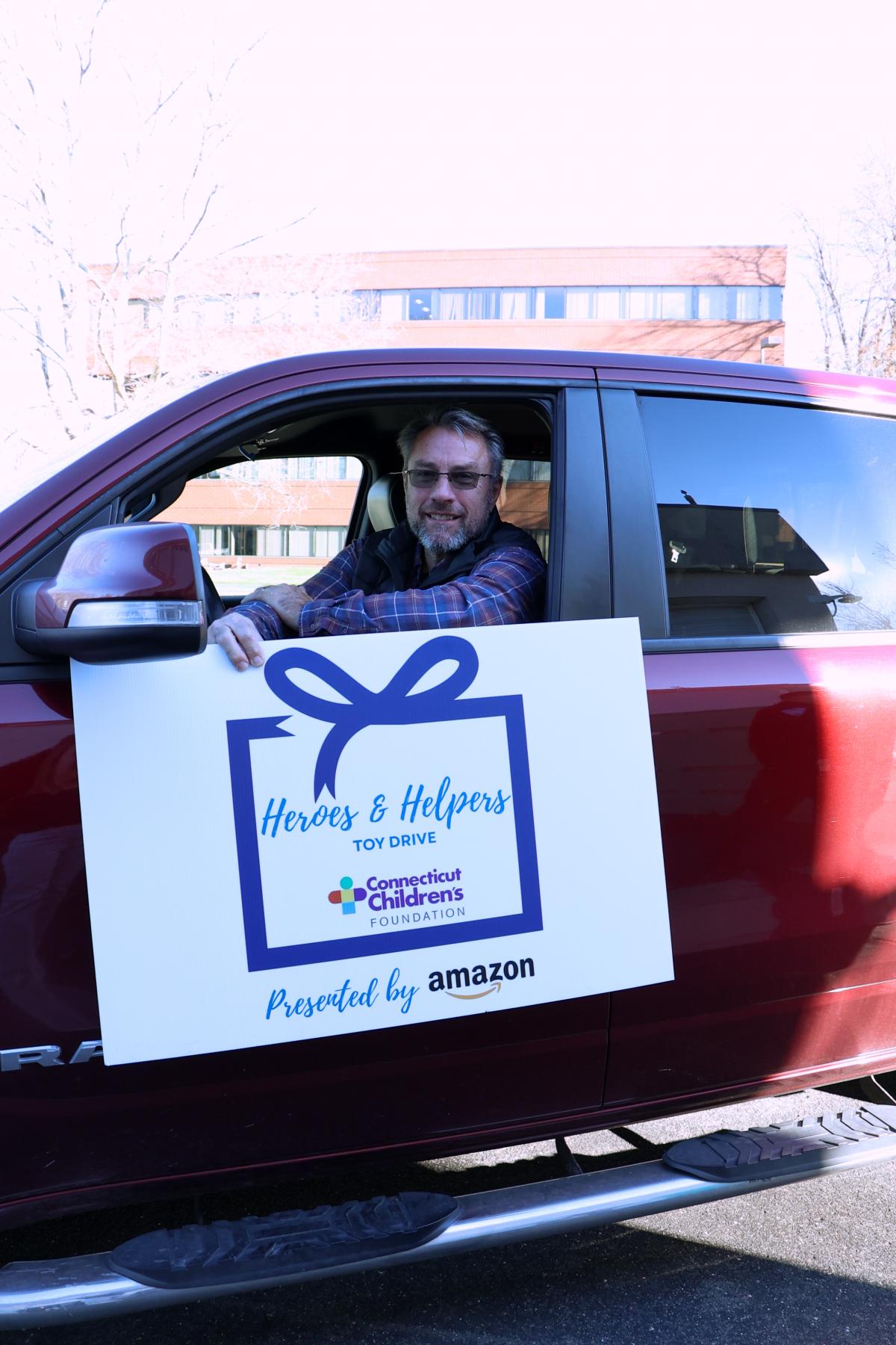 Business owner dropping off toys to Toy Drive event