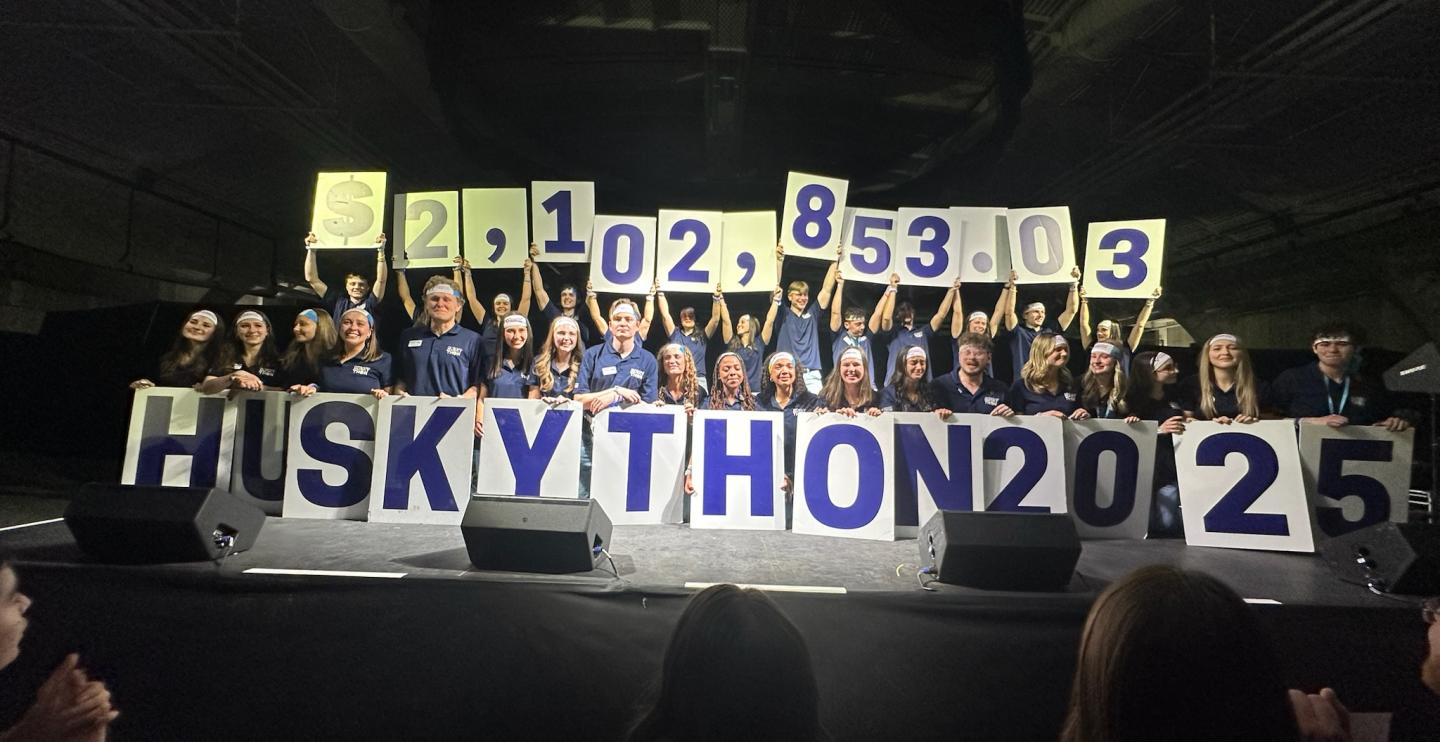 HuskyTHON 2025 Management Team breaking into tears as they announce having exceeded their most ambitious goal.