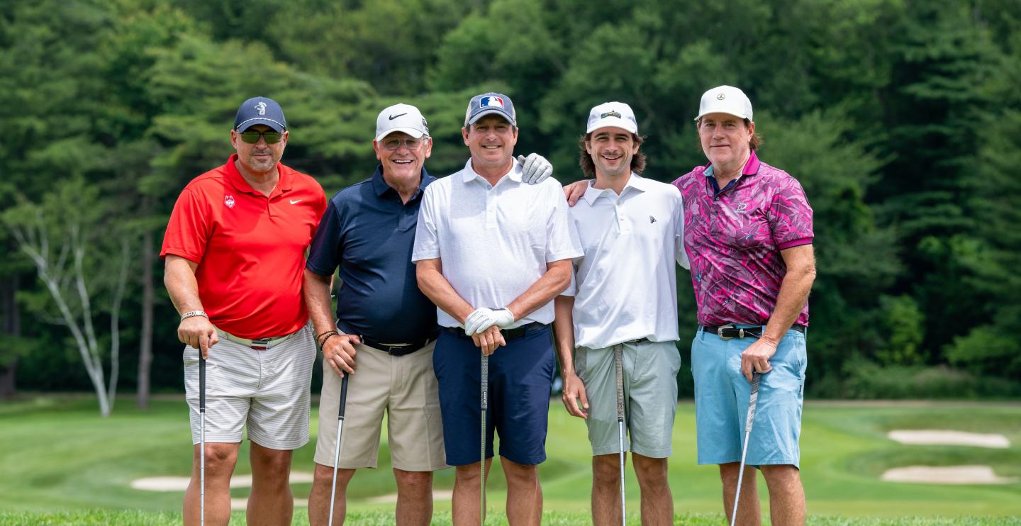 Geno and a team of golfers