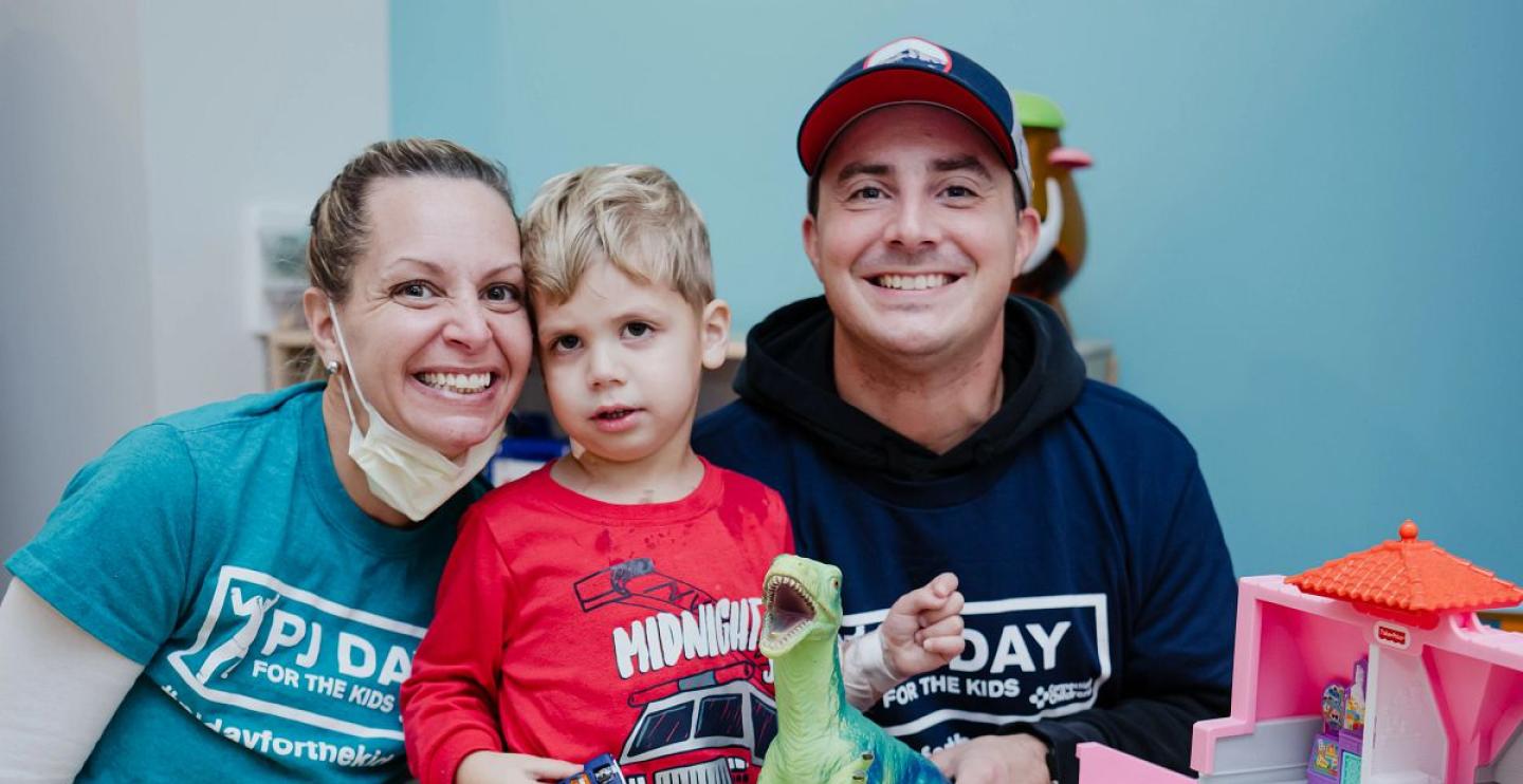 A patient participates in PJ Day with his care team and family