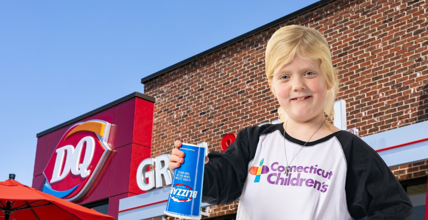 All-Star Emma holds a DQ Blizzard in front of a store