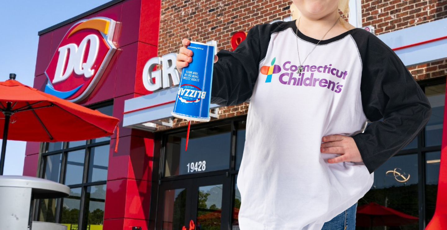 All-Star Emma holds a DQ Blizzard in front of a store