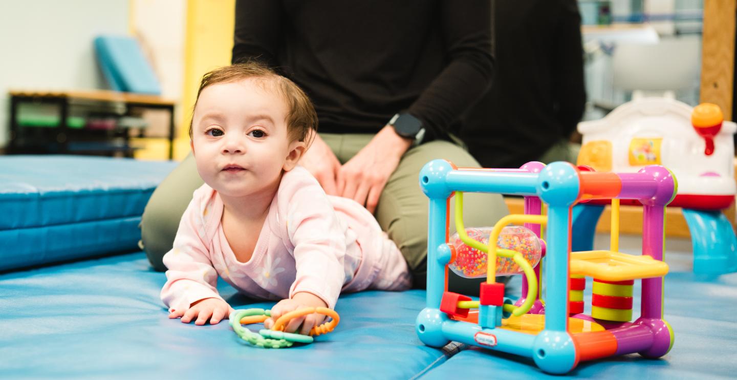 Baby playing with toys during Physical Therapy session