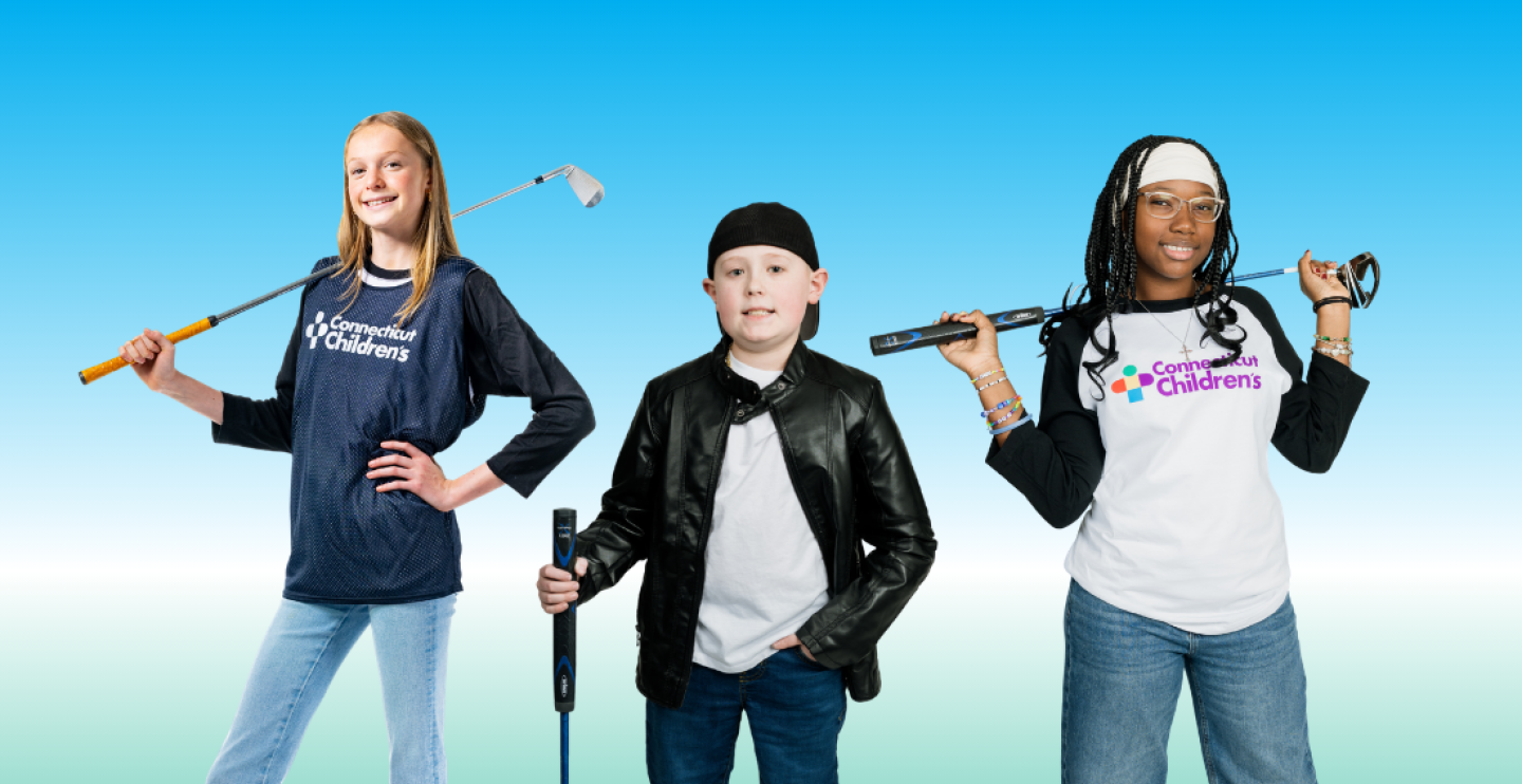 Patients holding golf clubs smiling