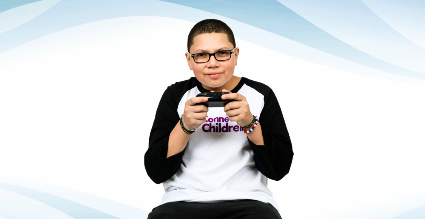 All-Star Elijah holding his game controller