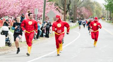Superhero runners running the 5K race